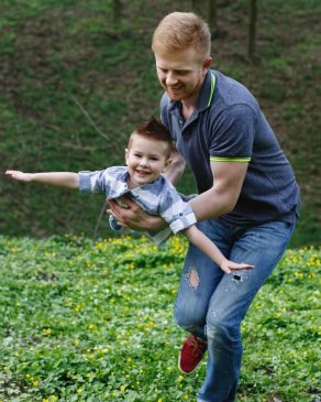 dad-whirls-his-son-like-airplane-playing-green-park_8353-5362-2